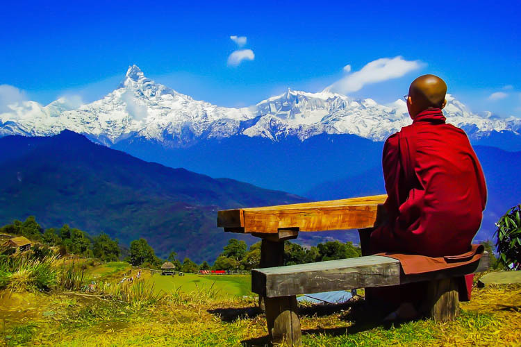 Buddhist Monk looking at the Annapurna Peak in Nepal