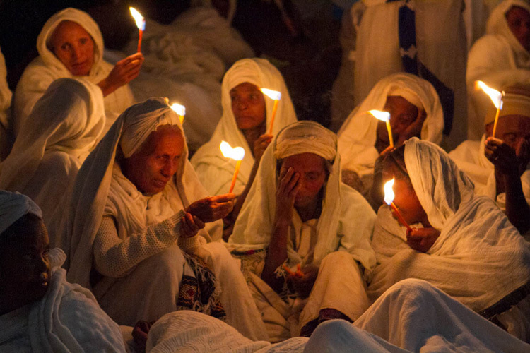 Praying with candles in a church in Lalibela, Ethiopia, Africa.